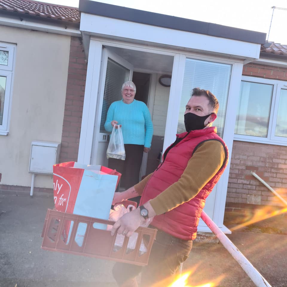 Image of volunteer delivering broth to doorstep